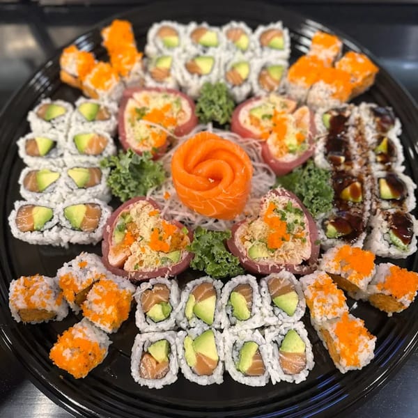 A large platter of Flame Sushi Japanese Grill's assorted sushi rolls, sashimi, and nigiri.